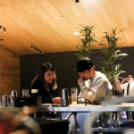 Woman and man laughing together while sitting at bar