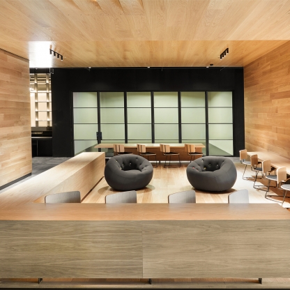 lobby area with two chairs and wooden walls and ceiling