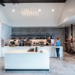 man serves a woman a coffee at the to-go shop REN