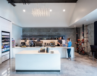 man serves a woman a coffee at the to-go shop REN