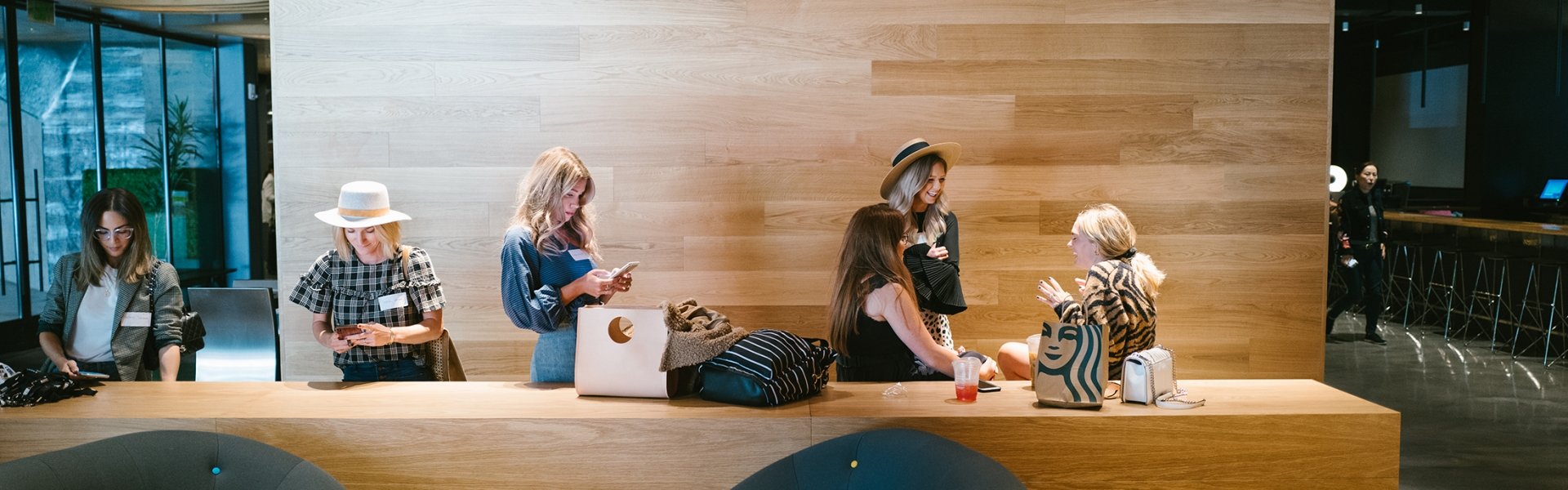 group of women gather in lobby to chat and work