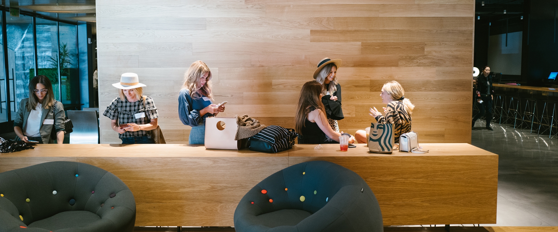group of women gather in lobby to chat and work