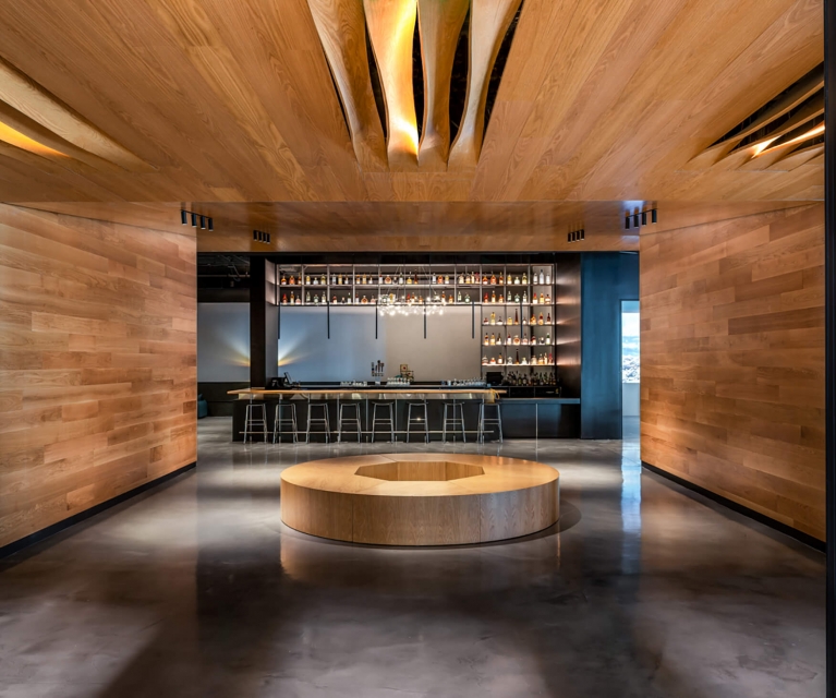 dramatic shot of the lobby area with bar at the back.