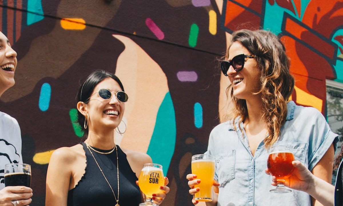 Four ladies drinking and laughing