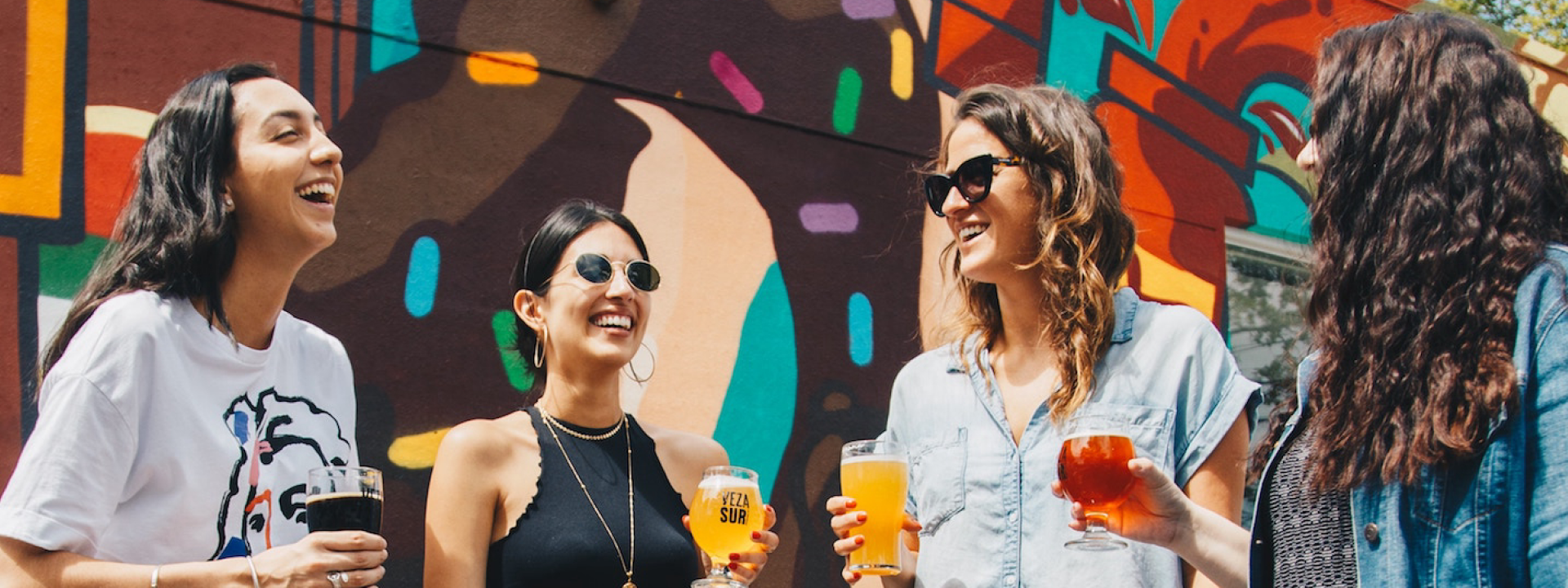 Four ladies drinking and laughing