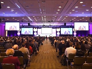 Moscone Cente filled with people sitting looking at screens