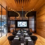 boardroom with wooden walls and ceiling, complete with stylized chandelier