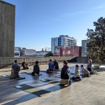 group gather for yoga session on the bei terrace