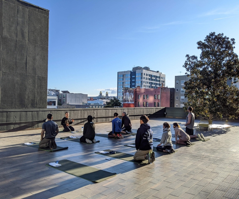 group gather for yoga session on the bei terrace