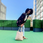 woman smiles at camera while standing on BEI terrace