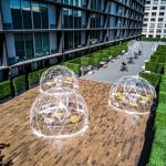 Activity lawn with dome enclosures over table and chair set ups